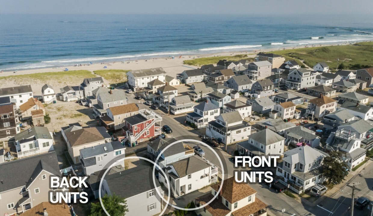 An aerial view of a house with a beach in the background.