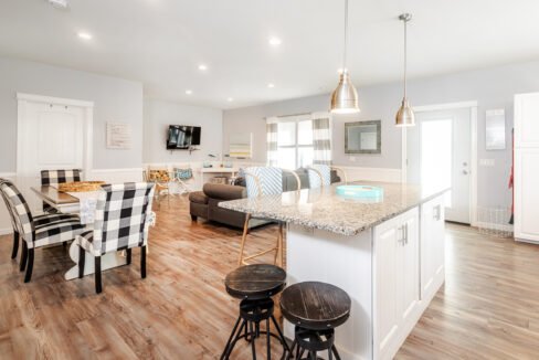 A kitchen, dining room and living room in a home.