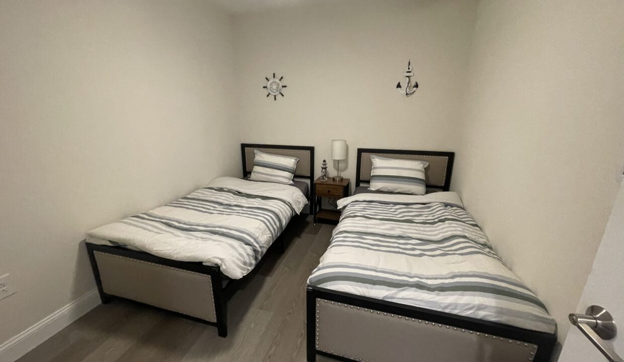 a couple of beds sitting in a bedroom next to each other.