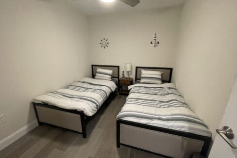 a couple of beds sitting in a bedroom next to each other.
