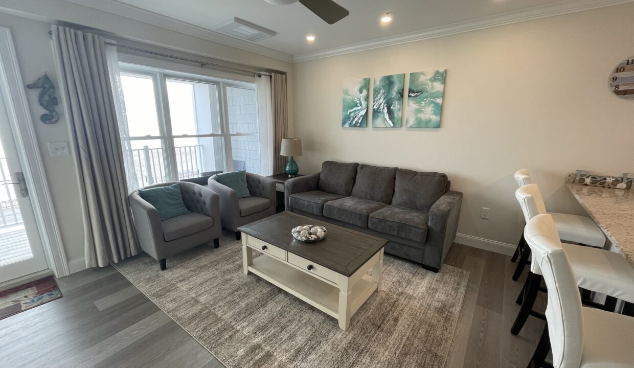 a living room filled with furniture and a flat screen tv.