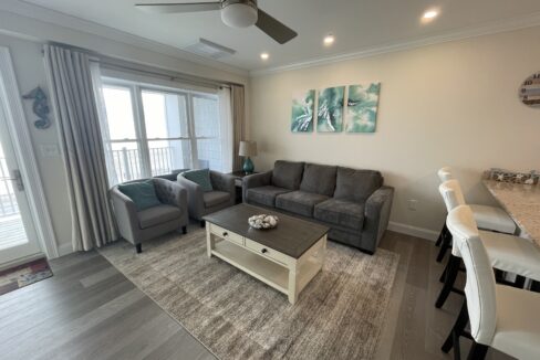 a living room filled with furniture and a flat screen tv.