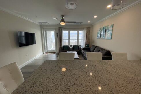 a living room with a couch a table and a tv.