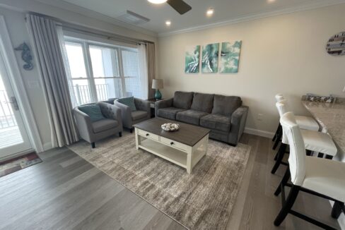 a living room filled with furniture and a flat screen tv.