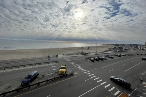 a parking lot with cars parked on the side of the road.