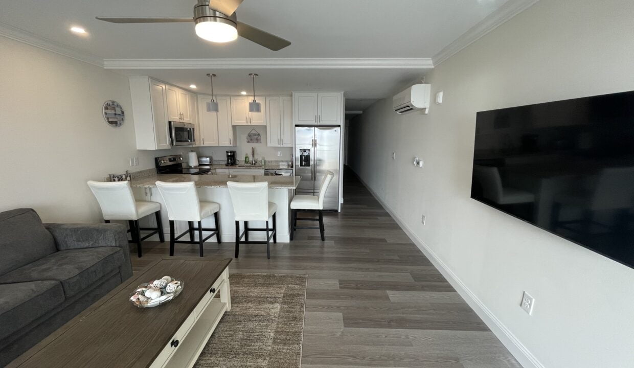 a living room filled with furniture and a flat screen tv.