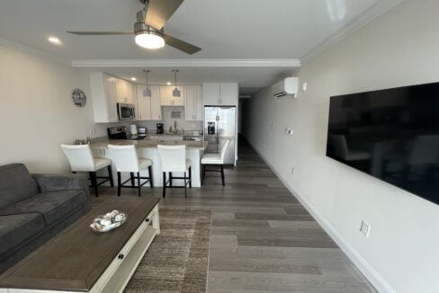 a living room filled with furniture and a flat screen tv.