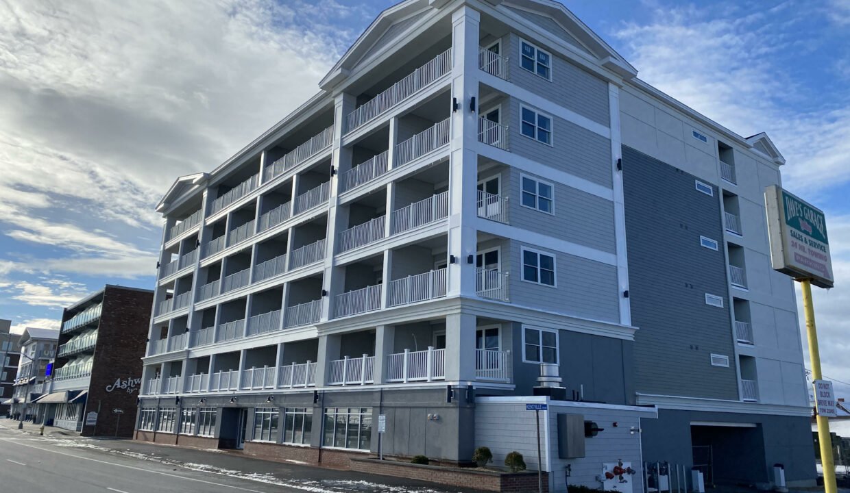 an apartment building on the corner of a street.