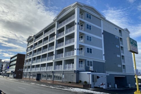 an apartment building on the corner of a street.