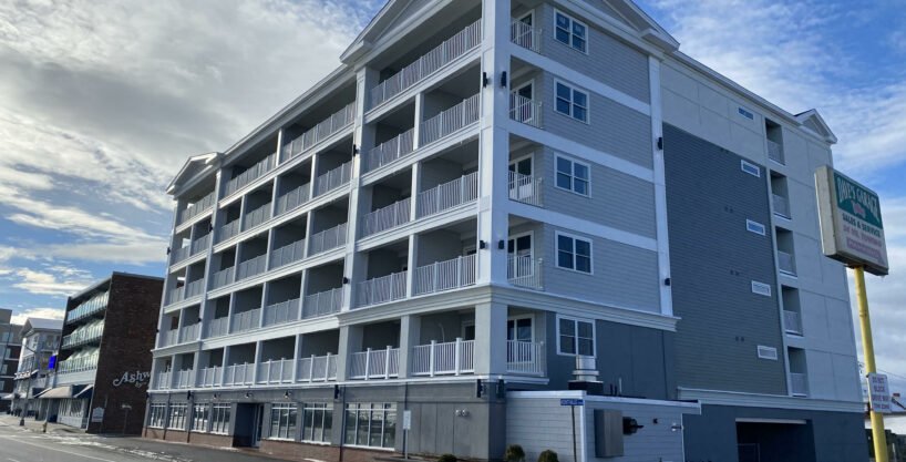 an apartment building on the corner of a street.