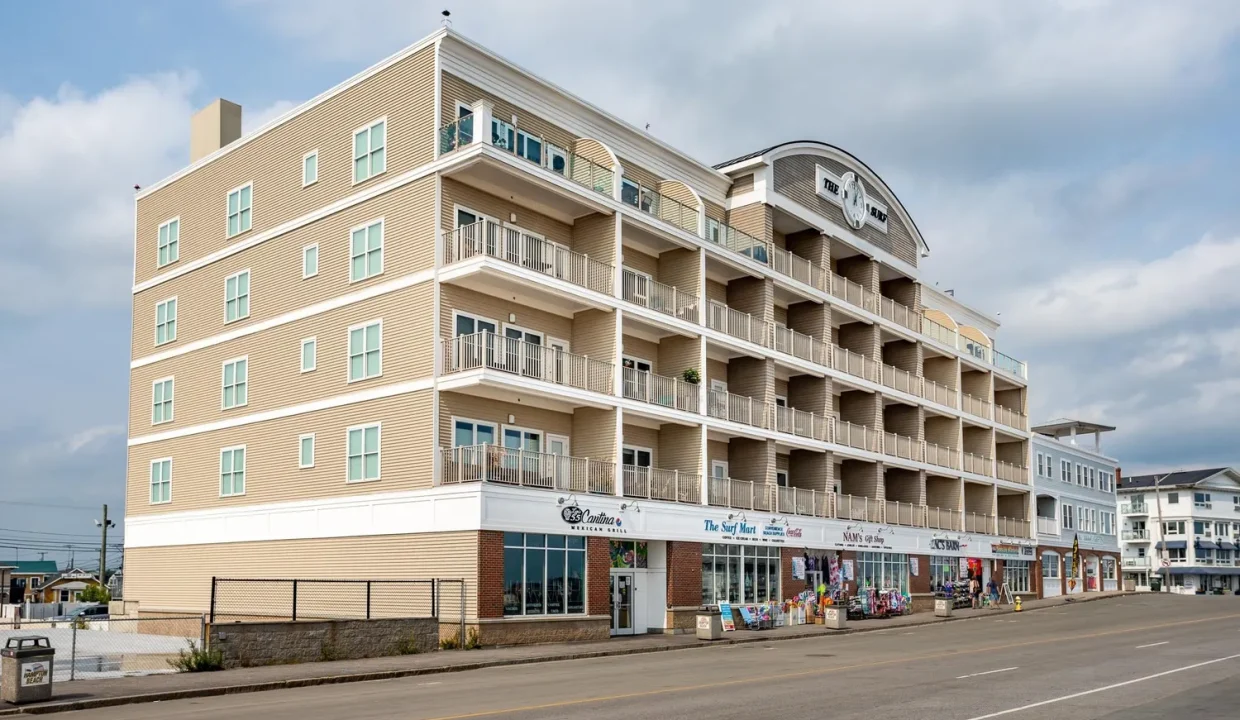 An apartment building on the corner of a street.