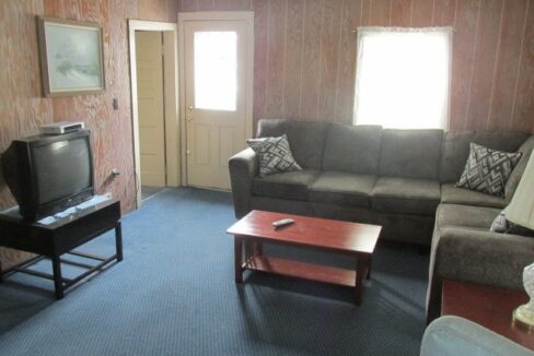 a living room filled with furniture and a flat screen tv.