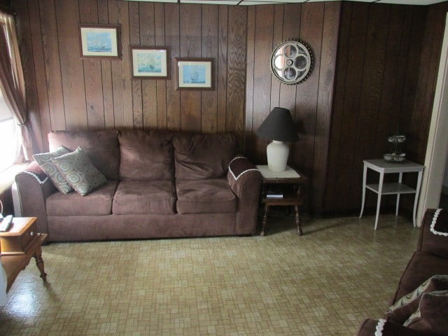 a living room with a brown couch and a table.