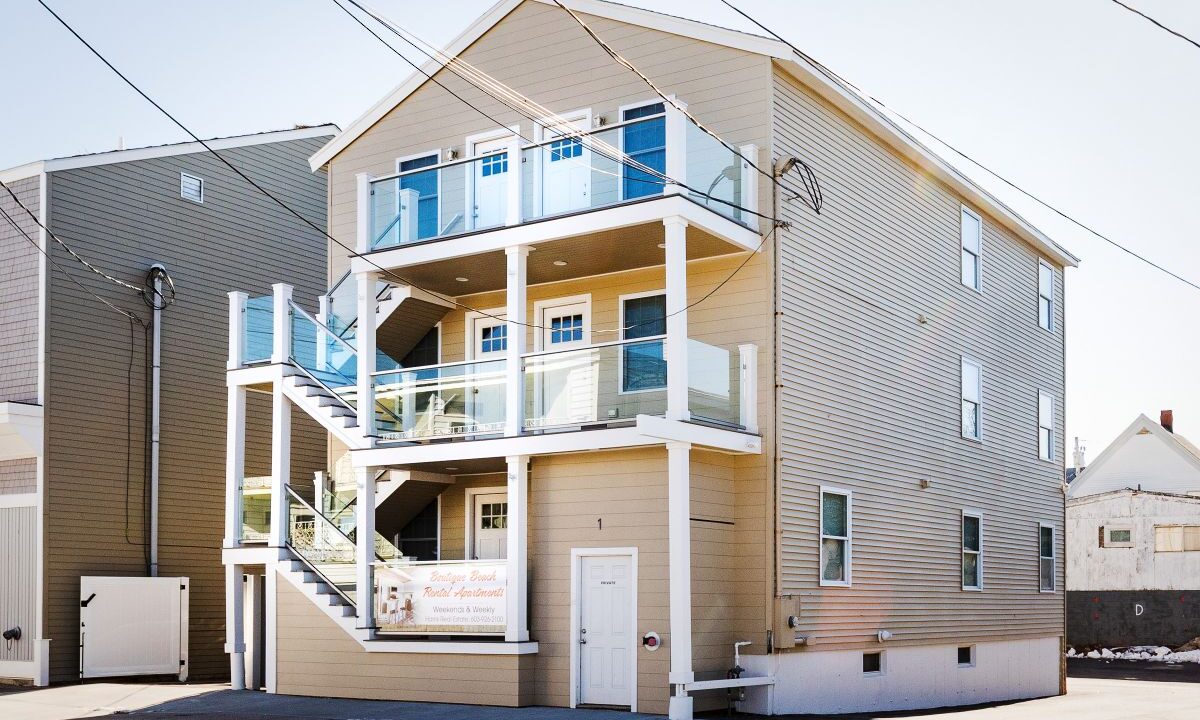 a two story house with a balcony and balconies.