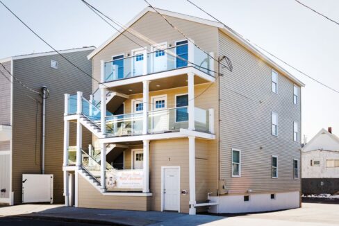 a two story house with a balcony and balconies.