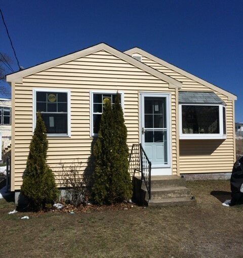 a house with a car parked in front of it.