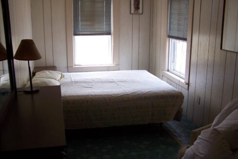 a bed sitting in a bedroom next to a window.