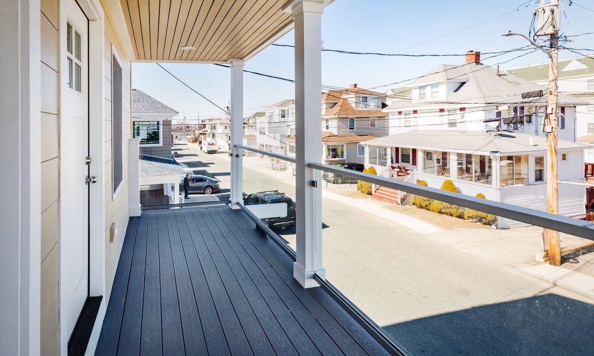 a balcony with a view of a street and houses.