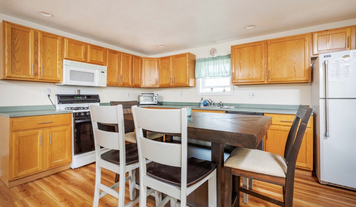 a kitchen with wooden floors and white appliances.