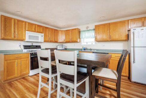 a kitchen with wooden floors and white appliances.