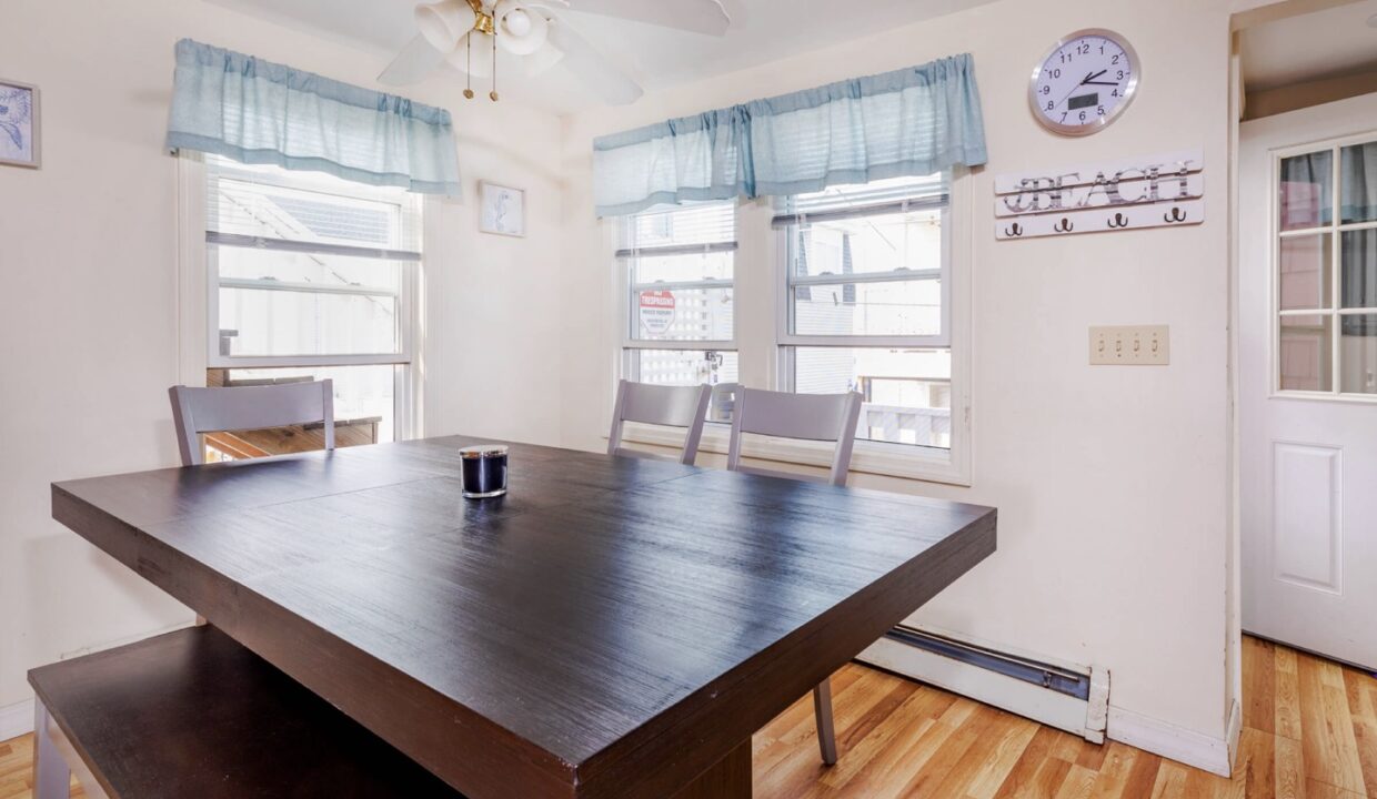 a room with a wooden table and a clock on the wall.