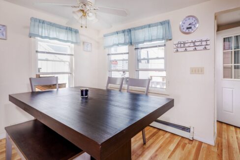 a room with a wooden table and a clock on the wall.