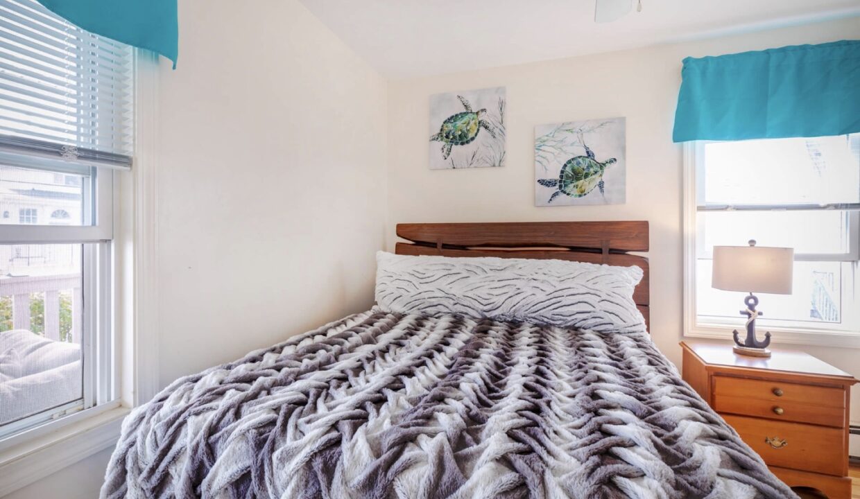 a bed sitting in a bedroom next to a window.