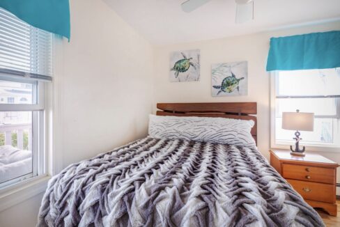 a bed sitting in a bedroom next to a window.