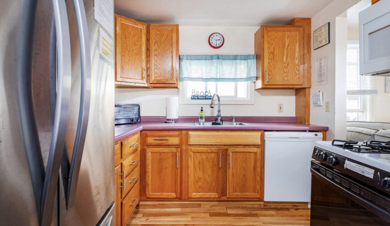 a kitchen with wooden cabinets and white appliances.