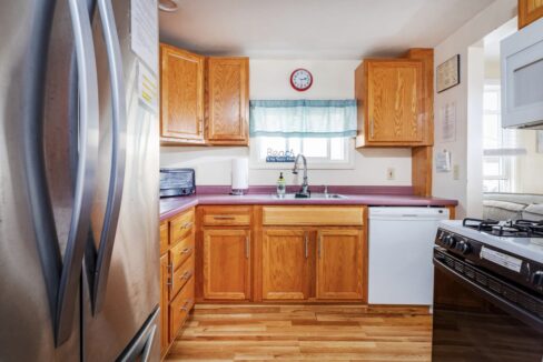 a kitchen with wooden cabinets and white appliances.