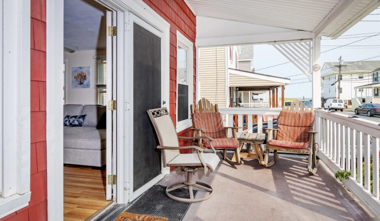 a porch with chairs and a table on it.