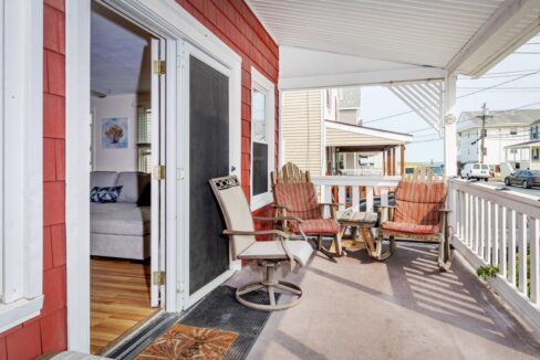 a porch with chairs and a table on it.