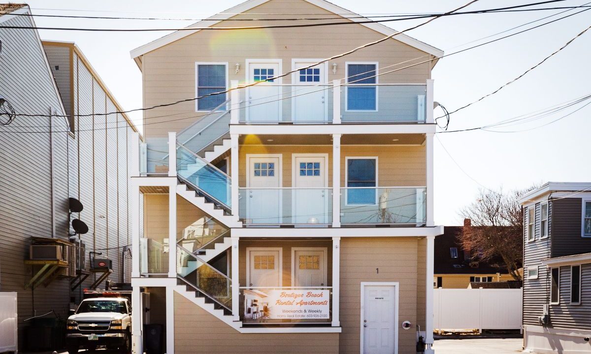 a two story house with a staircase leading up to the second story.