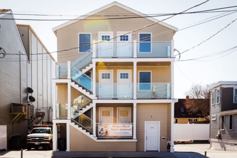 a two story house with a staircase leading up to the second story.