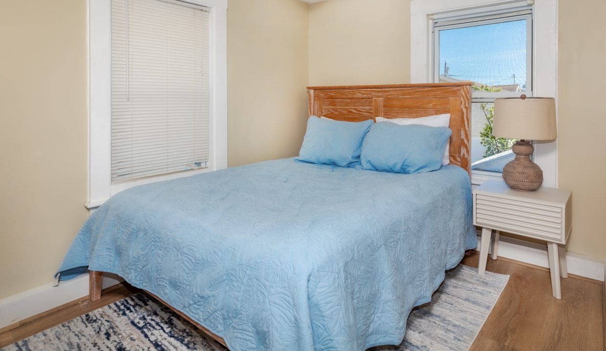 a bedroom with a bed and a blue blanket.