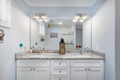 a bathroom with a large mirror and two sinks.