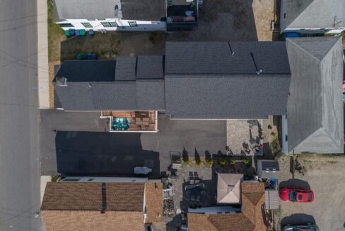 an aerial view of a house with a car parked in front of it.