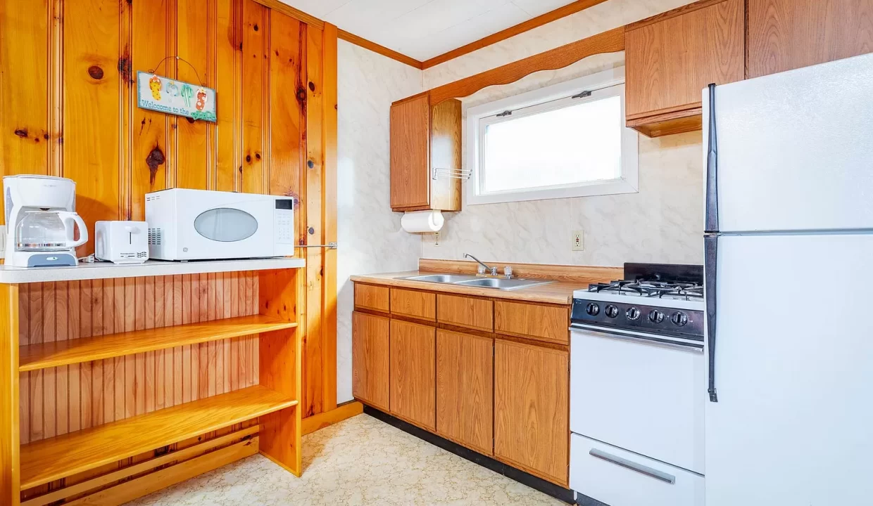 a kitchen with wood paneling and white appliances.