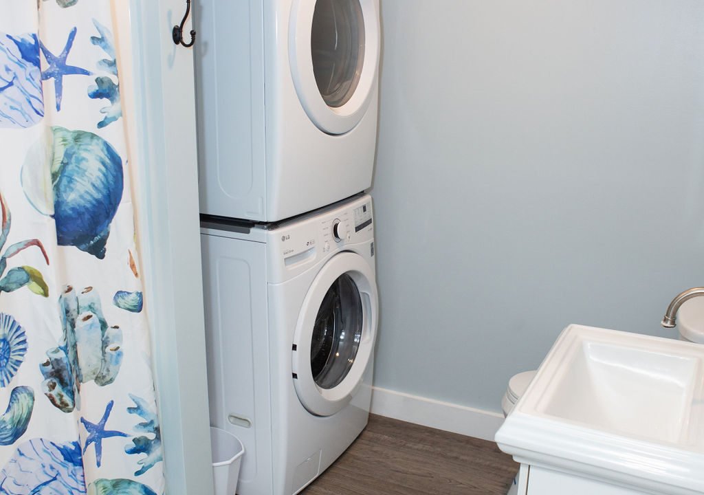 a washer and dryer in a small bathroom.