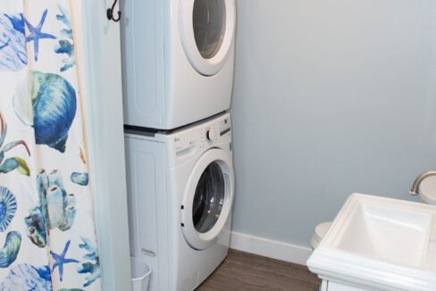 a washer and dryer in a small bathroom.