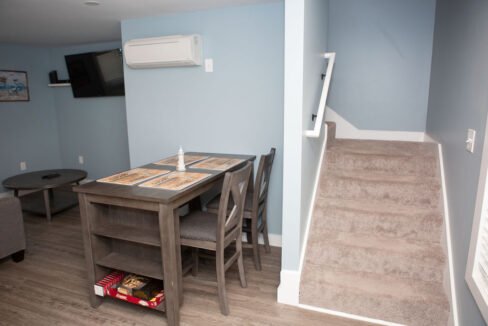 a room with a table, chairs, and a television.