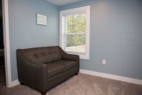 a living room with a chair and a window.