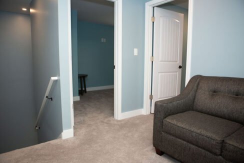 a living room with a chair and a door.