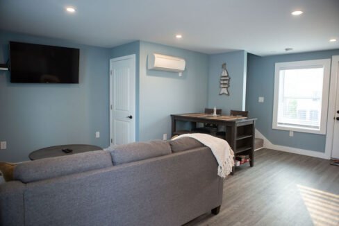 a living room filled with furniture and a flat screen tv.