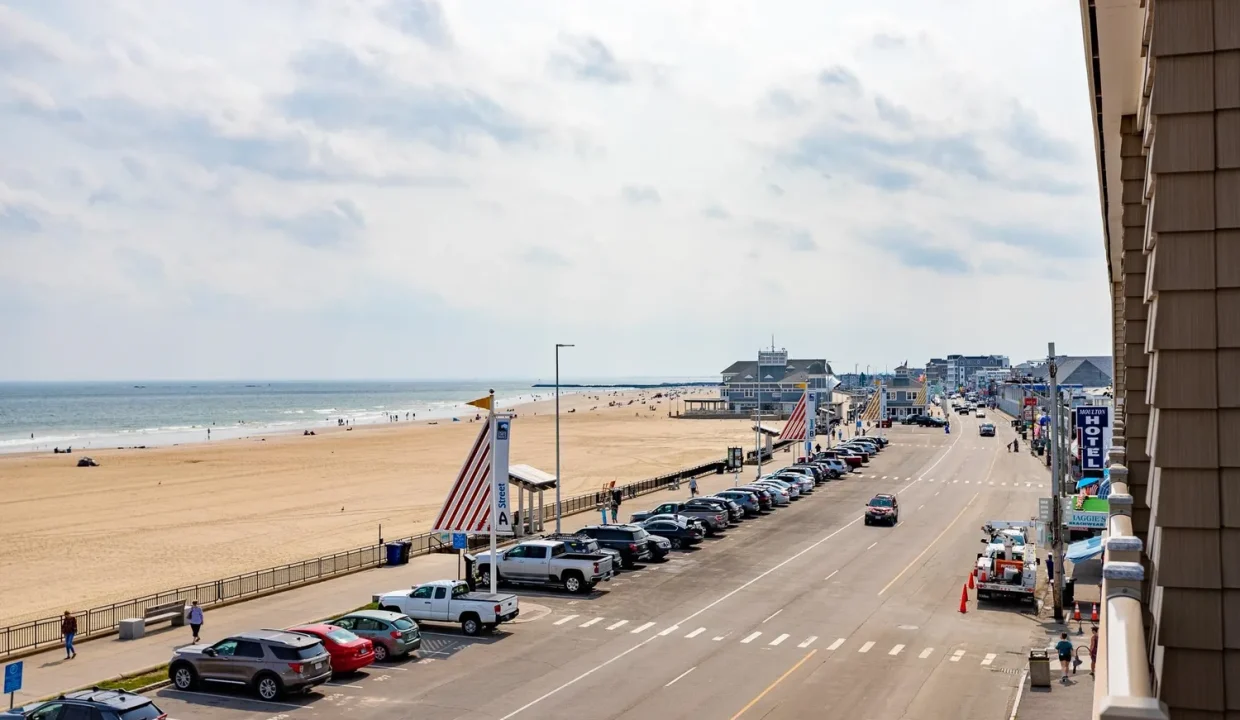 A view of the beach from the balcony of a hotel.