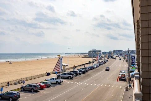 A view of the beach from the balcony of a hotel.