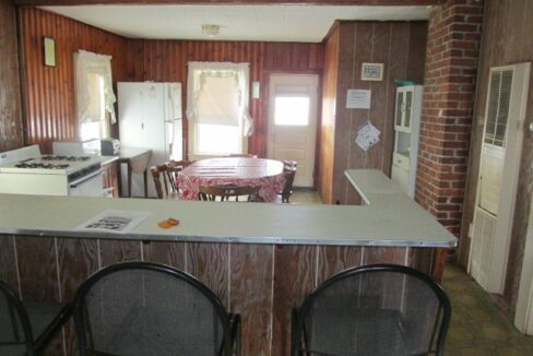 a kitchen with a table and chairs in it.