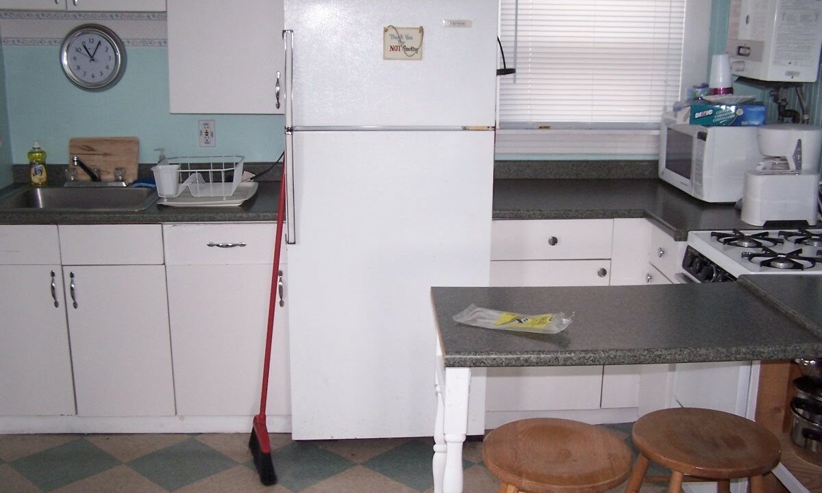 a white refrigerator freezer sitting inside of a kitchen.