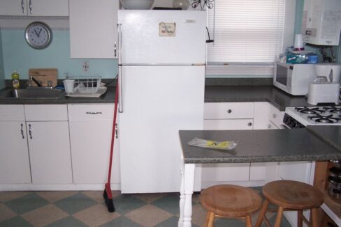 a white refrigerator freezer sitting inside of a kitchen.