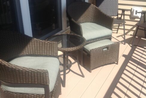 a couple of chairs sitting on top of a wooden floor.